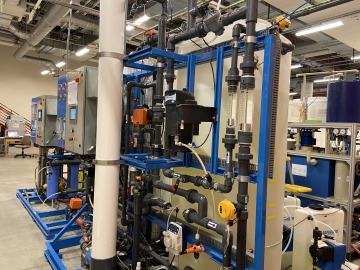 The photo shows a very large reverse osmosis machine in a lab at the WEST Center.